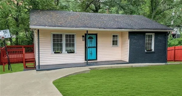 a front view of a house with a garden