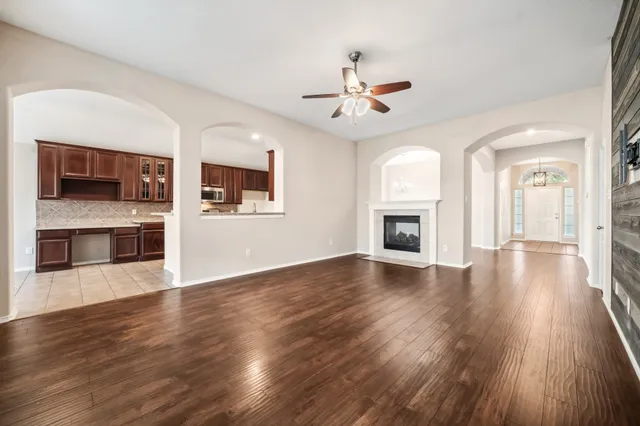 a view of a living room a fireplace with wooden floor and a window