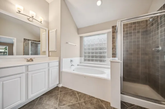 a spacious bathroom with sink shower and bathtub