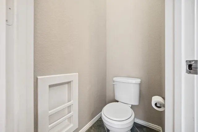 a white toilet sitting next to a shower