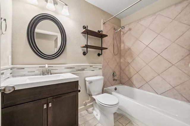 a bathroom with a sink a toilet and a mirror