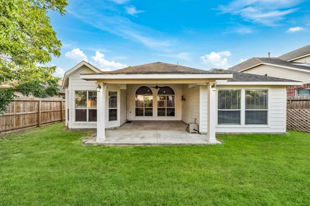 a view of an house with backyard porch and garden