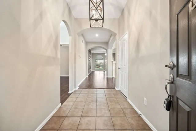 a view of a hallway with a chandelier