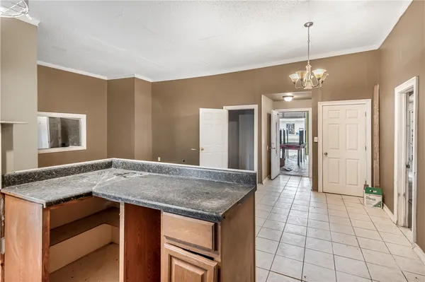a kitchen with granite countertop white cabinets and sink