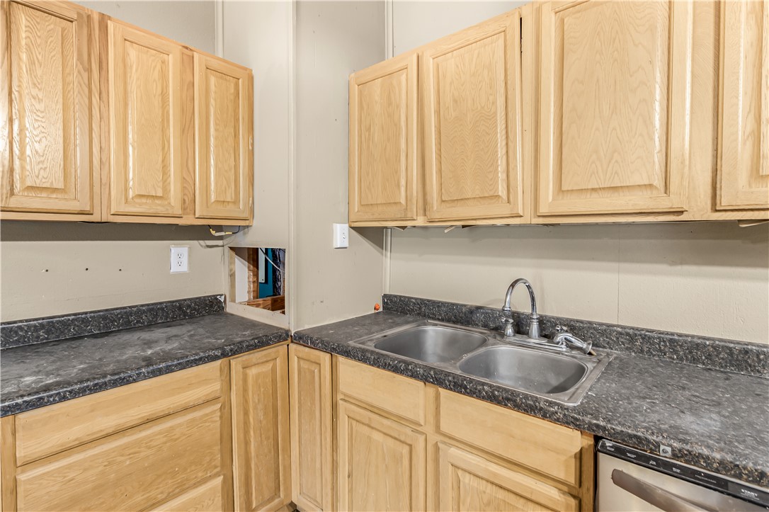 124 12th Street Somerville, TX 77879 - Photo 18 of 42 a kitchen with granite countertop white cabinets and sink