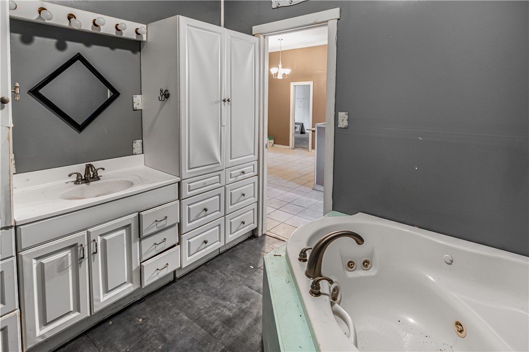 124 12th Street Somerville, TX 77879 - Photo 20 of 42 a bathroom with a tub sink and mirror
