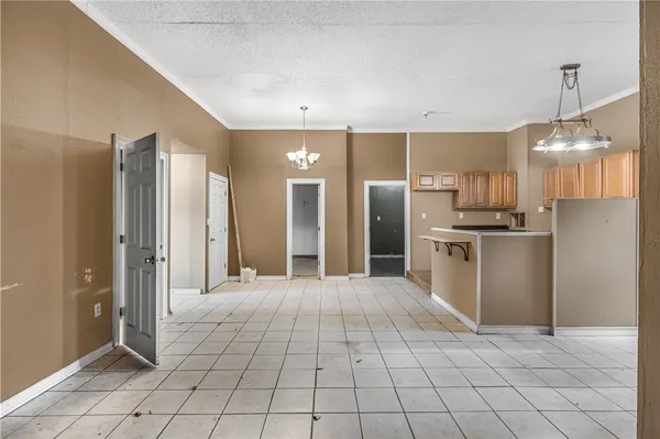 a kitchen with stainless steel appliances granite countertop a refrigerator a sink dishwasher a stove and a refrigerator with wooden floor