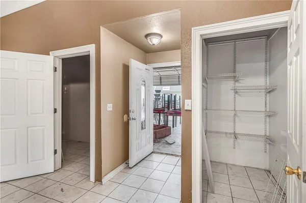 a view of an empty room with window and cabinet