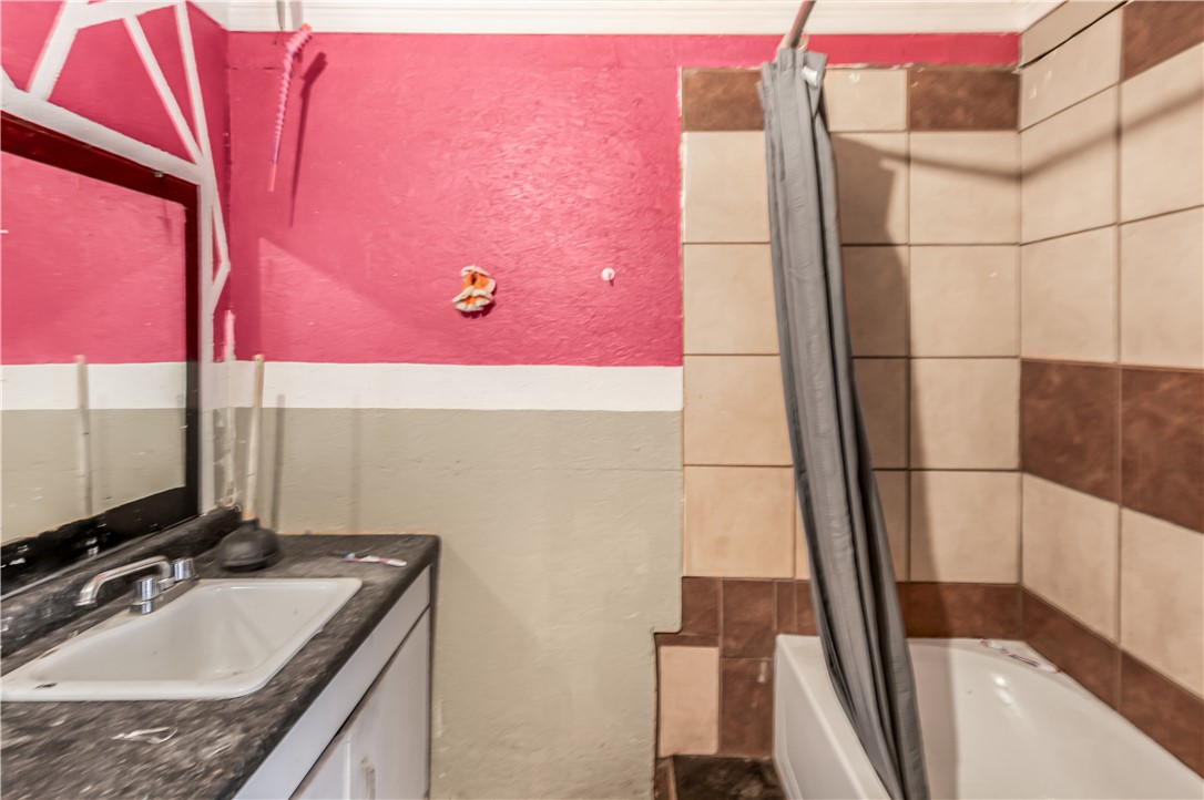 124 12th Street Somerville, TX 77879 - Photo 31 of 42 a bathroom with a granite countertop sink and a mirror