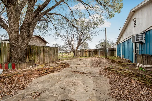 a backyard of a house with a tree