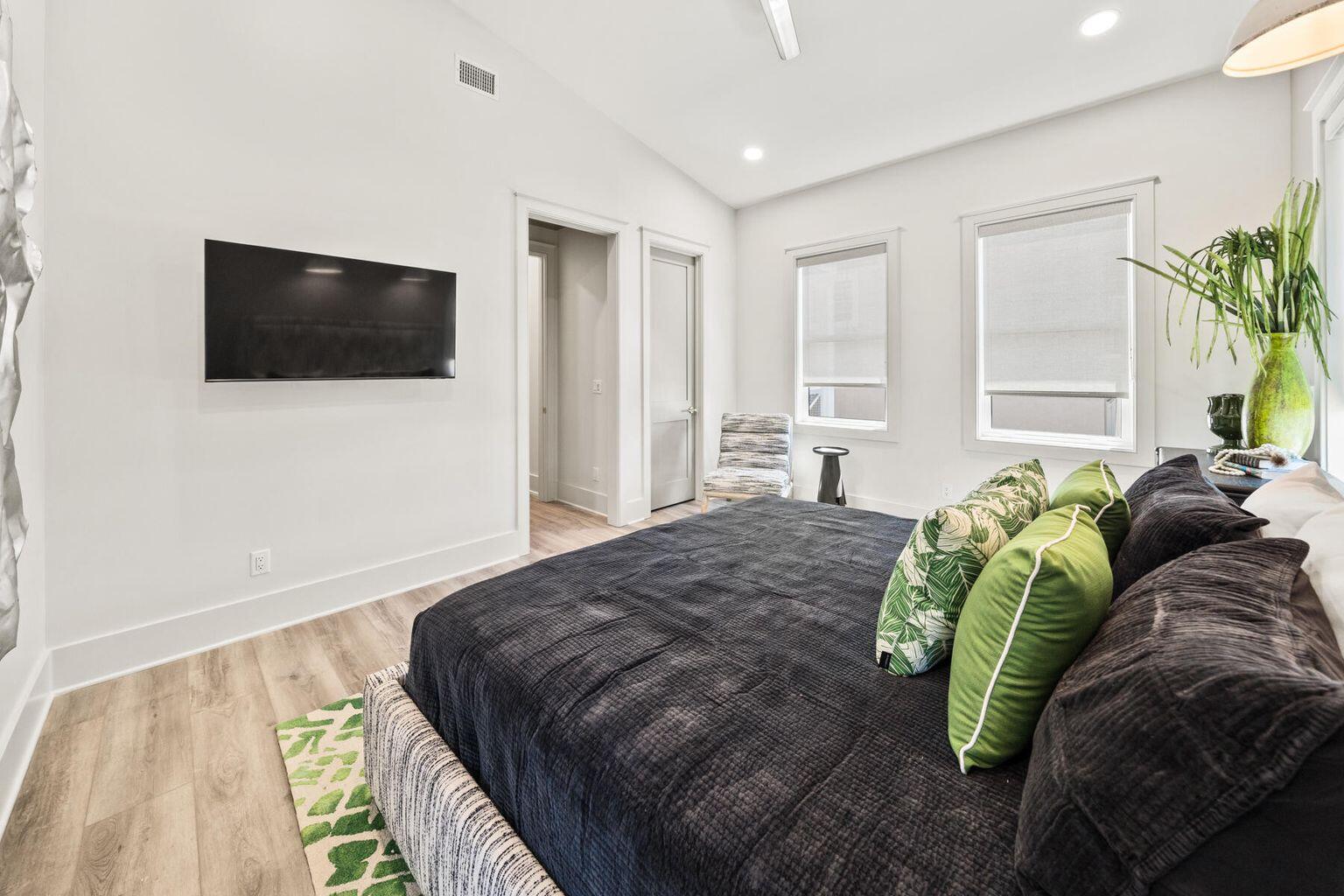 21524 Front Beach Road Panama City Beach, FL 32413 - Photo 35 of 73 a spacious bedroom with a bed and a flat screen tv