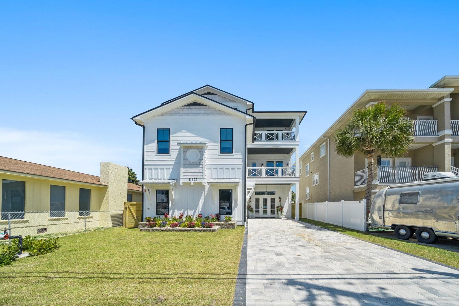 21524 Front Beach Road Panama City Beach, FL 32413 - Photo 5 of 73 a front view of a house with a yard