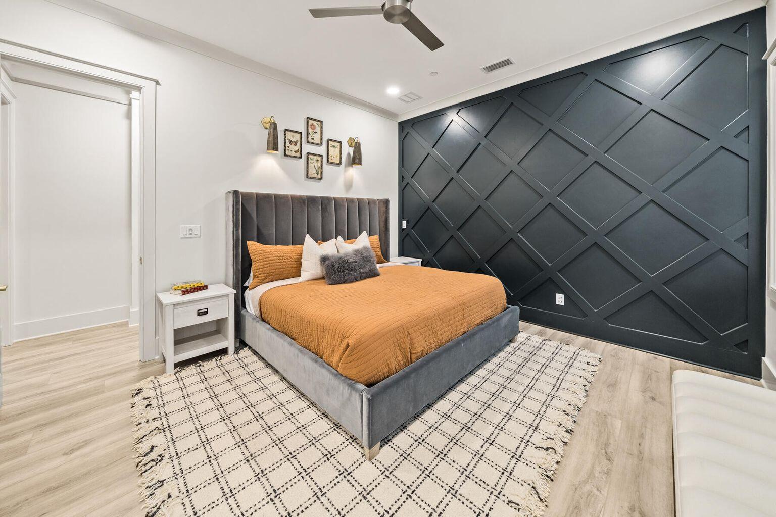 21524 Front Beach Road Panama City Beach, FL 32413 - Photo 53 of 73 a bedroom with a bed and a table with wooden floor