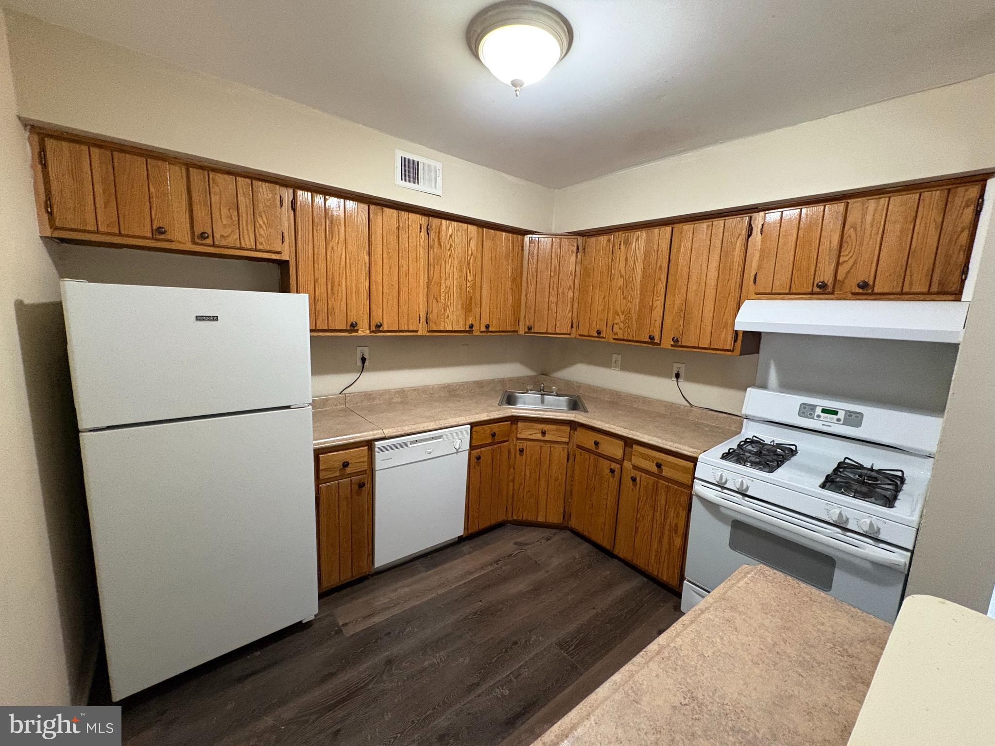 2840 Brighton Place, Unit 2 Philadelphia, PA 19149 - Photo 9 of 13 a kitchen with a white stove top oven and refrigerator