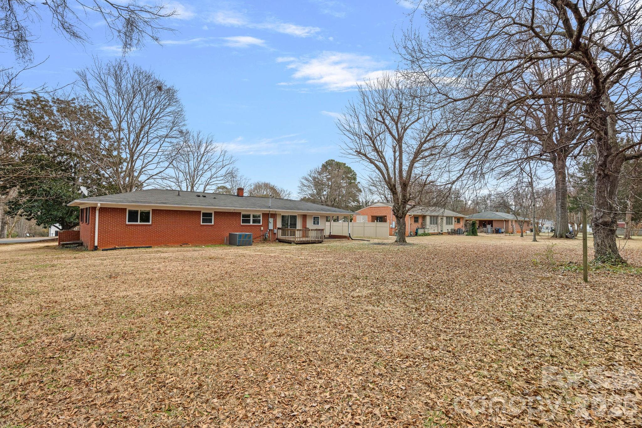 337 Fieldstone Road Mooresville, NC 28115 - Photo 20 of 25 a large tree in front of a brick building