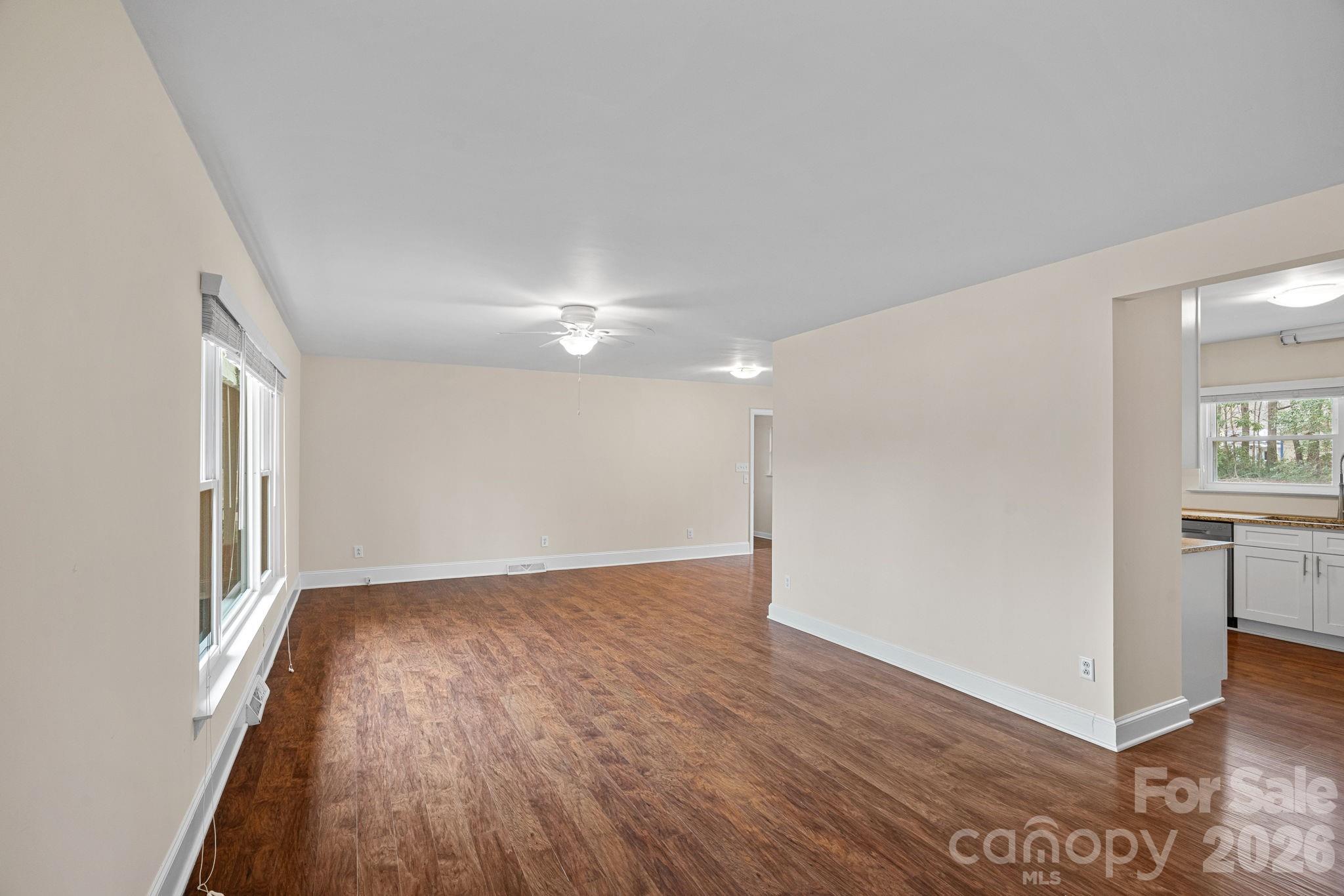337 Fieldstone Road Mooresville, NC 28115 - Photo 3 of 25 an empty room with wooden floor and windows