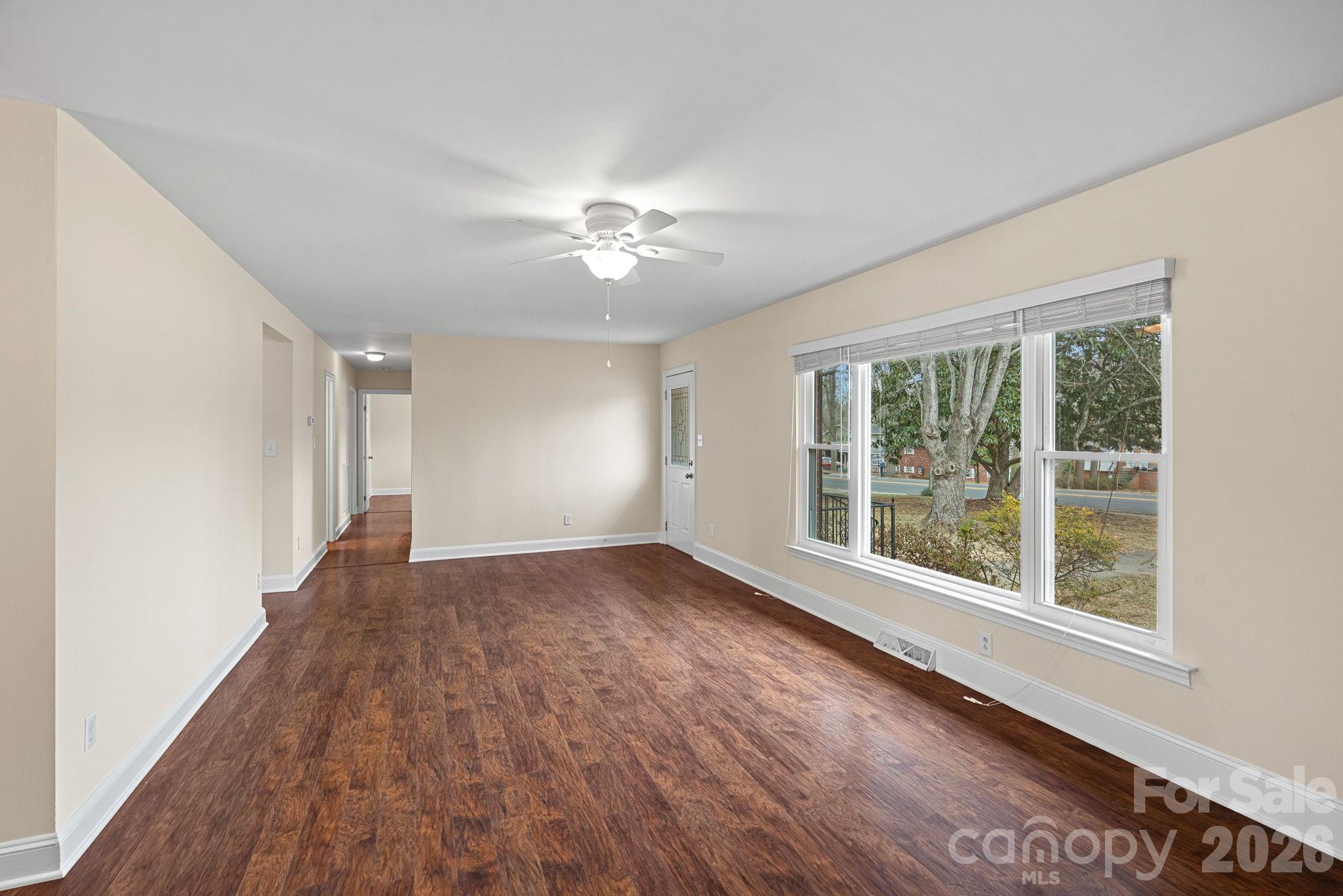337 Fieldstone Road Mooresville, NC 28115 - Photo 4 of 25 a view of an empty room with a window and wooden floor