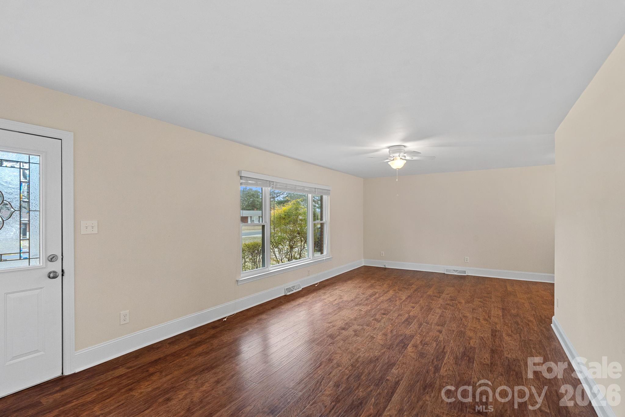 337 Fieldstone Road Mooresville, NC 28115 - Photo 5 of 25 a view of an empty room with wooden floor and a window