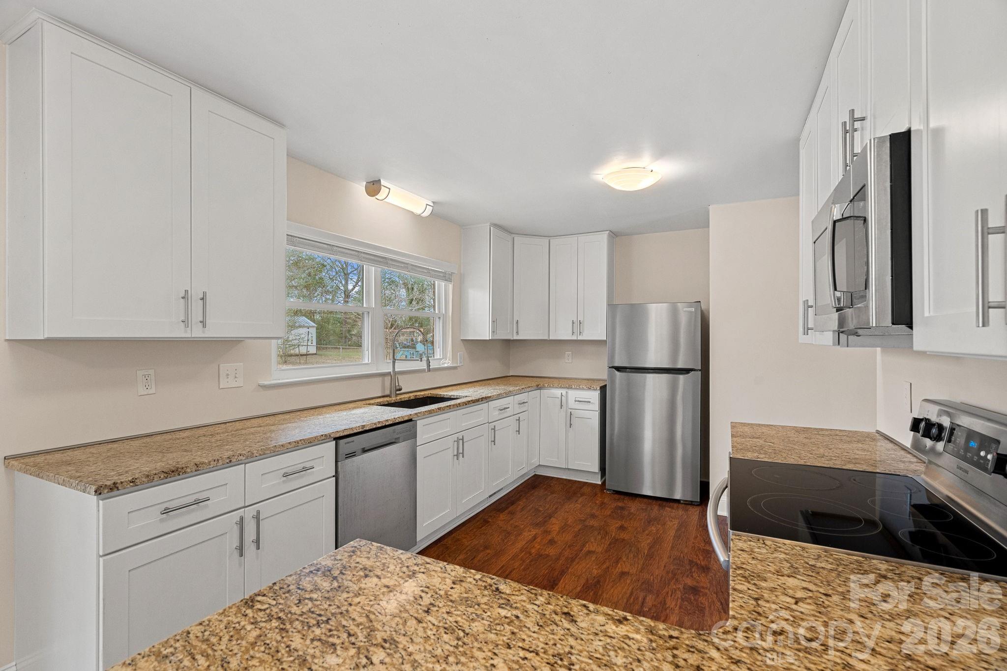 337 Fieldstone Road Mooresville, NC 28115 - Photo 6 of 25 a kitchen with a sink stove and refrigerator