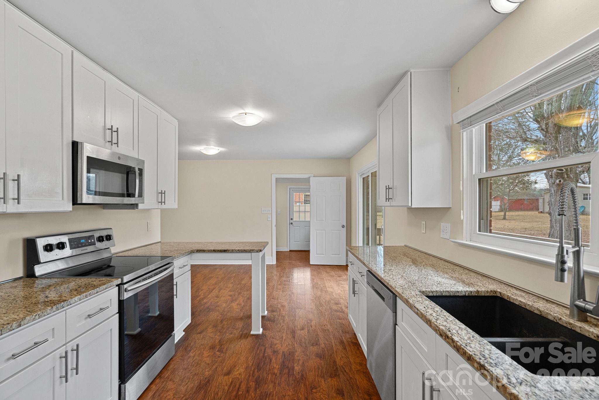 337 Fieldstone Road Mooresville, NC 28115 - Photo 8 of 25 a kitchen with stainless steel appliances granite countertop a sink stove and microwave