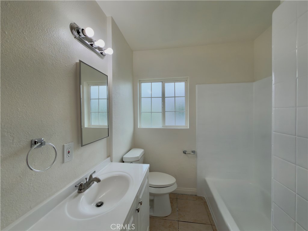 332 East Rosewood Street Rialto, CA 92376 - Photo 13 of 22 a bathroom with a sink toilet and shower
