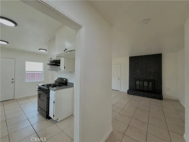 a kitchen with granite countertop a stove and cabinets