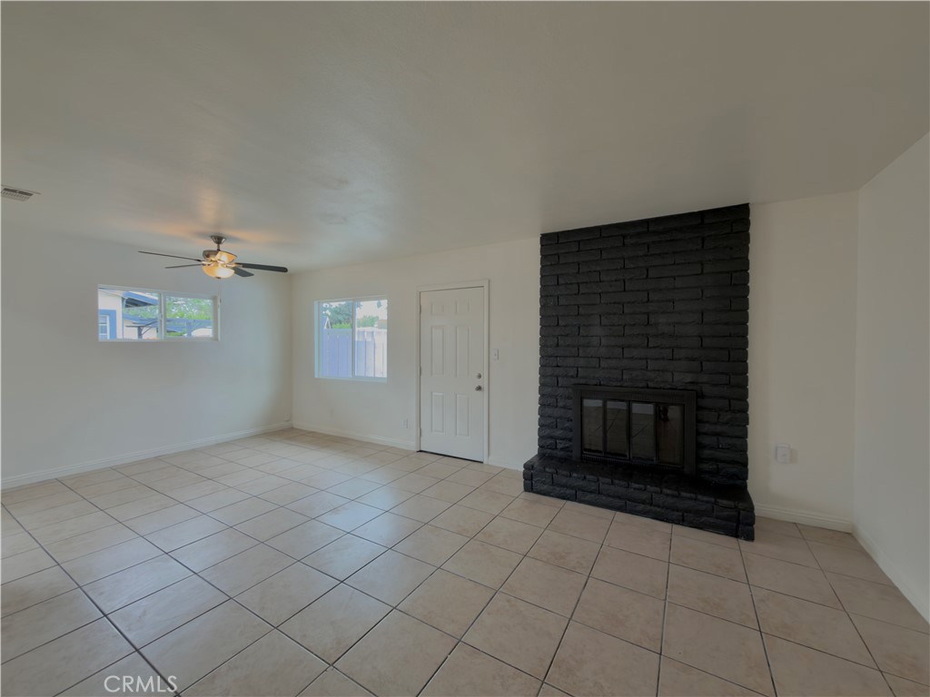 332 East Rosewood Street Rialto, CA 92376 - Photo 4 of 22 a view of an empty room with window and fireplace