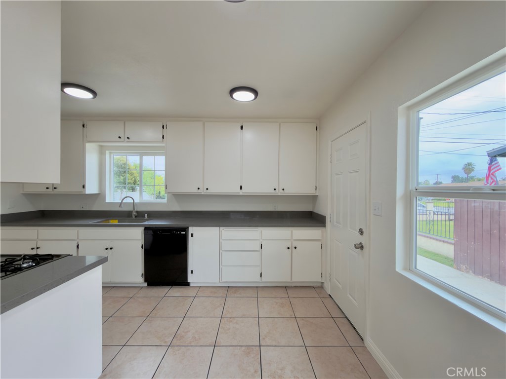 332 East Rosewood Street Rialto, CA 92376 - Photo 6 of 22 a kitchen with a sink a stove and cabinets