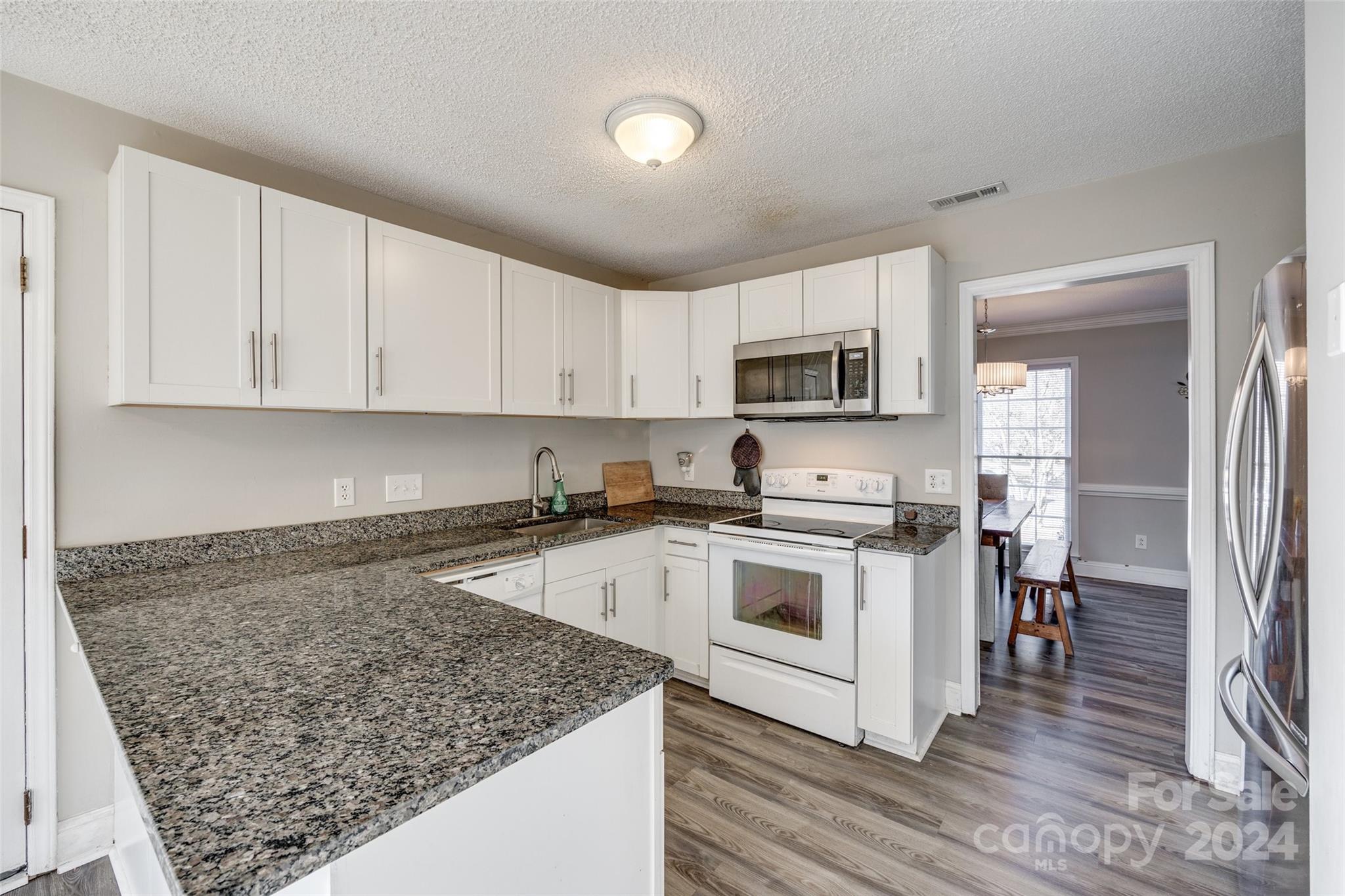 2801 Briar Ridge Drive Charlotte, NC 28270 - Photo 11 of 32 a kitchen with stainless steel appliances granite countertop a stove top oven a sink and a microwave