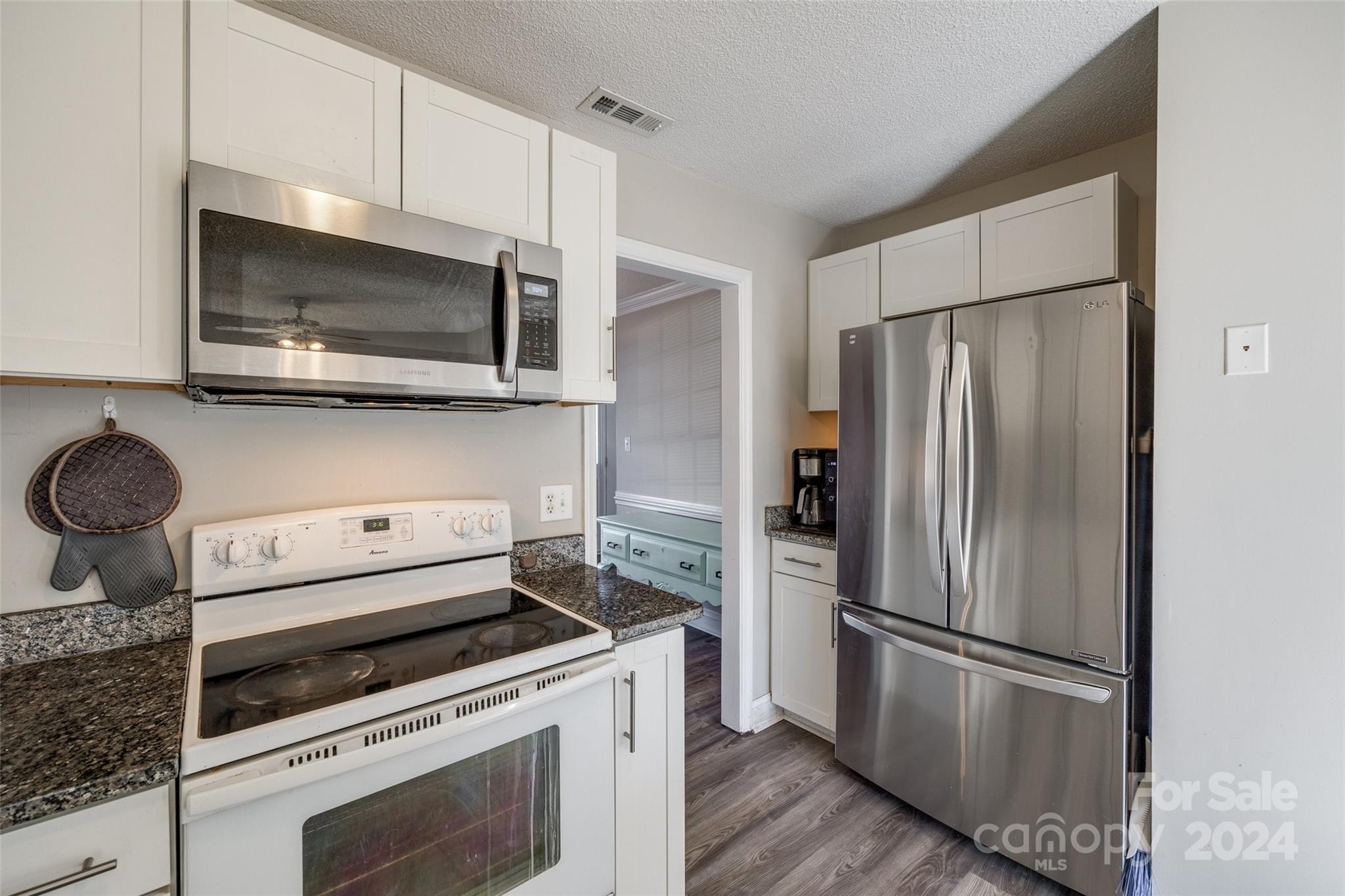 2801 Briar Ridge Drive Charlotte, NC 28270 - Photo 12 of 32 a kitchen with a refrigerator stove and microwave