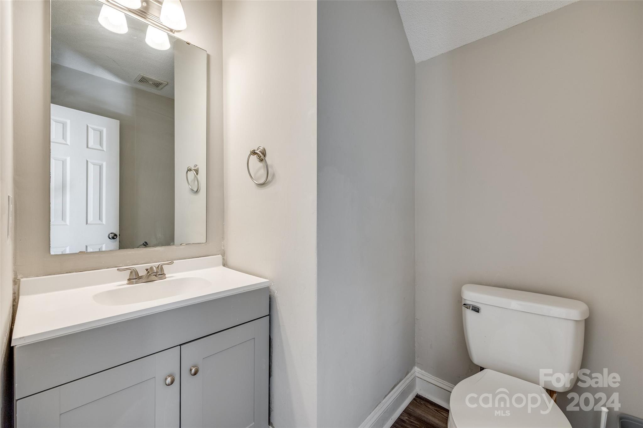 2801 Briar Ridge Drive Charlotte, NC 28270 - Photo 16 of 32 a bathroom with a toilet sink and mirror