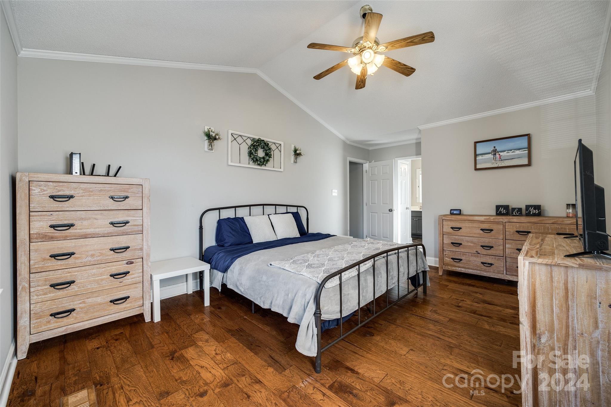 2801 Briar Ridge Drive Charlotte, NC 28270 - Photo 18 of 32 a bedroom with a bed and a flat tv screen on the dresser