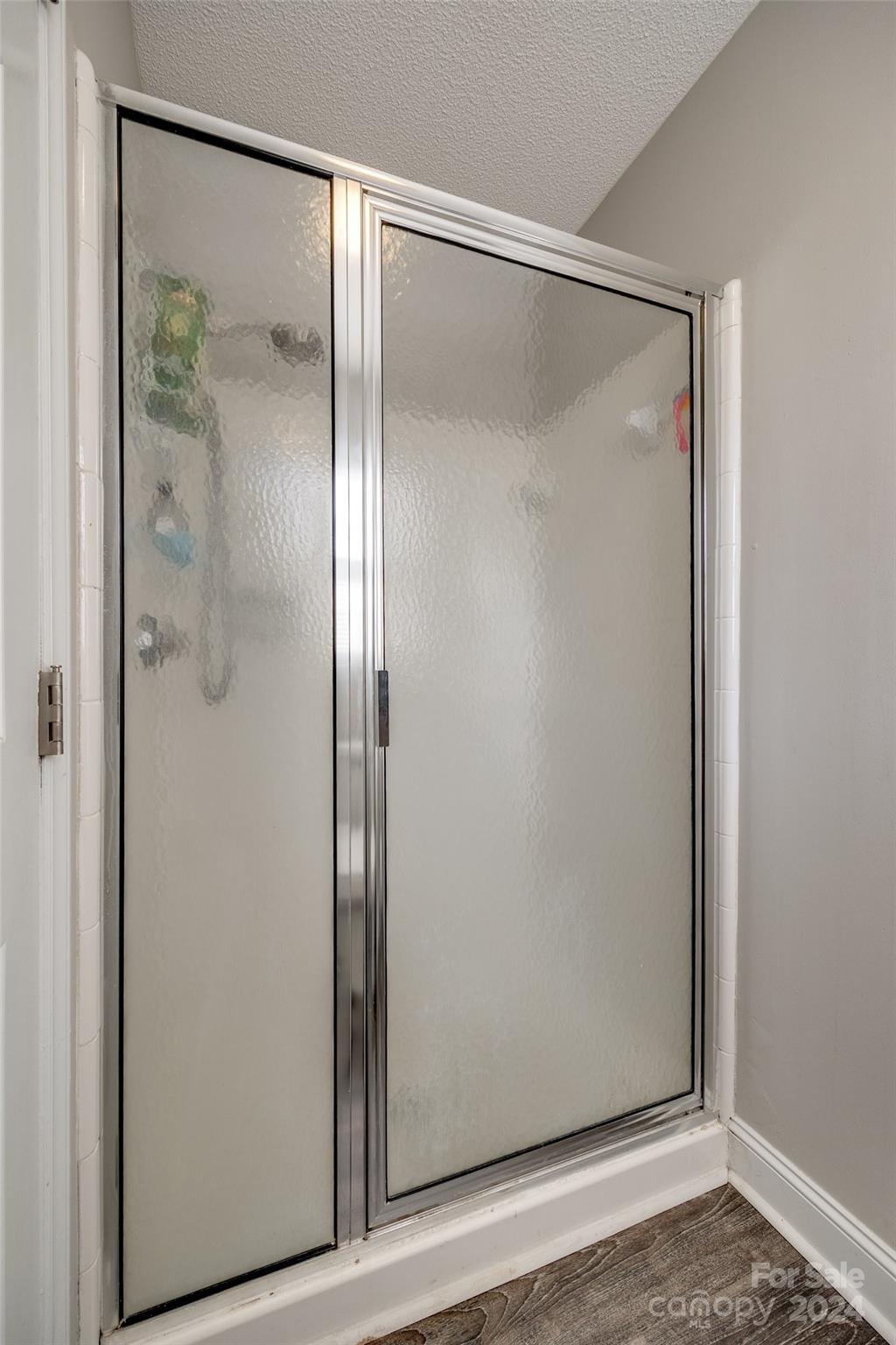 2801 Briar Ridge Drive Charlotte, NC 28270 - Photo 20 of 32 a bathroom with a glass shower door and a mirror