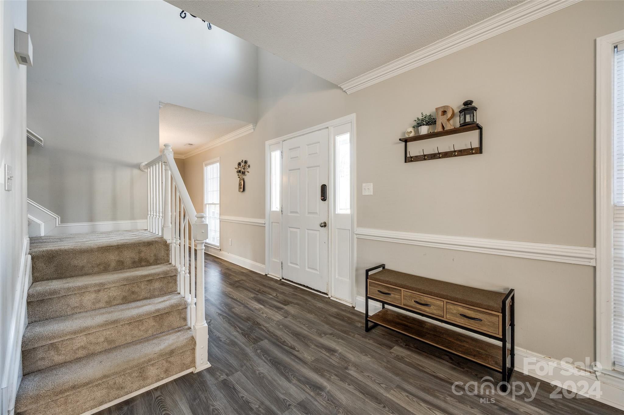 2801 Briar Ridge Drive Charlotte, NC 28270 - Photo 3 of 32 a view of a livingroom with wooden floor and stairs