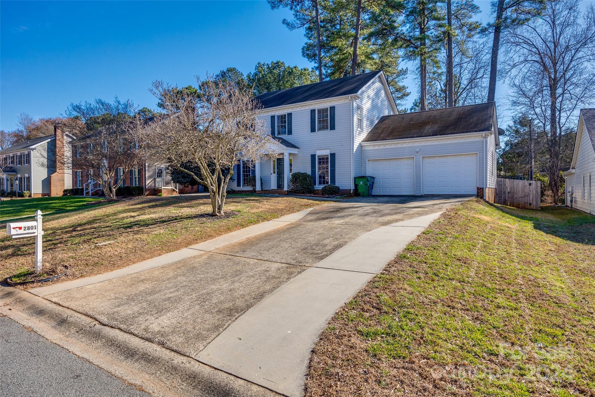 2801 Briar Ridge Drive Charlotte, NC 28270 - Photo 31 of 32 a front view of a house with a yard and garage