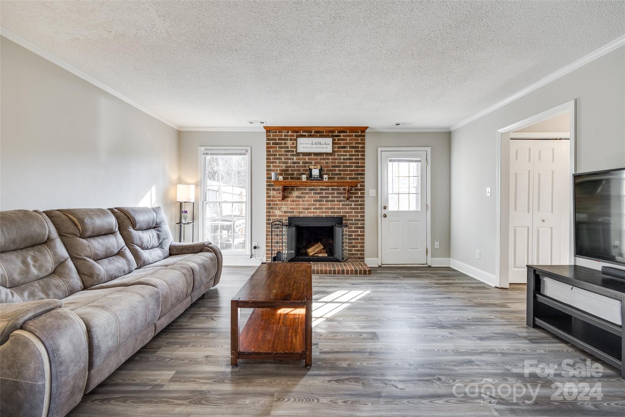 2801 Briar Ridge Drive Charlotte, NC 28270 - Photo 6 of 32 a living room with furniture and a fireplace