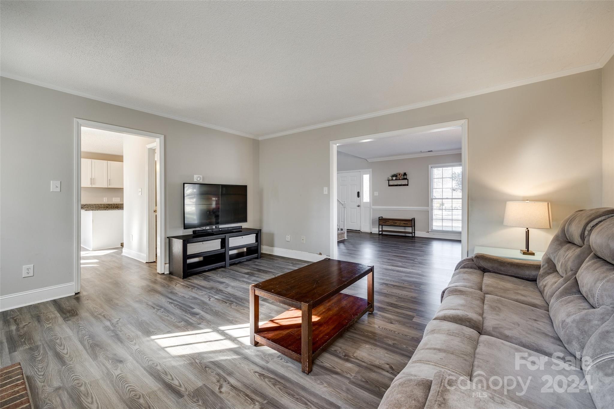 2801 Briar Ridge Drive Charlotte, NC 28270 - Photo 7 of 32 a living room with furniture and a flat screen tv