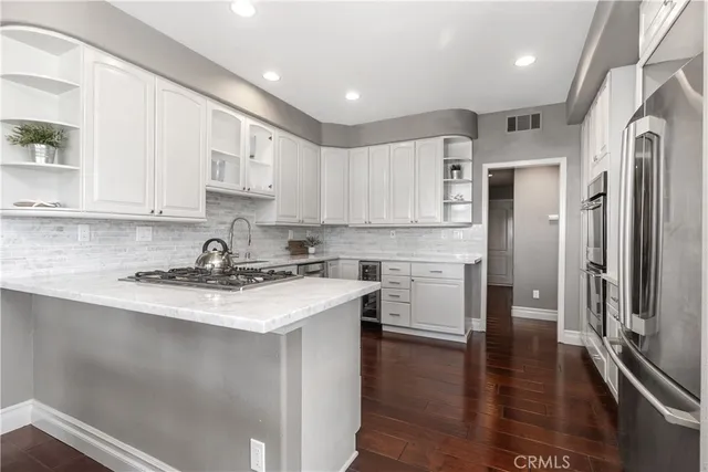a kitchen with white cabinets and white appliances