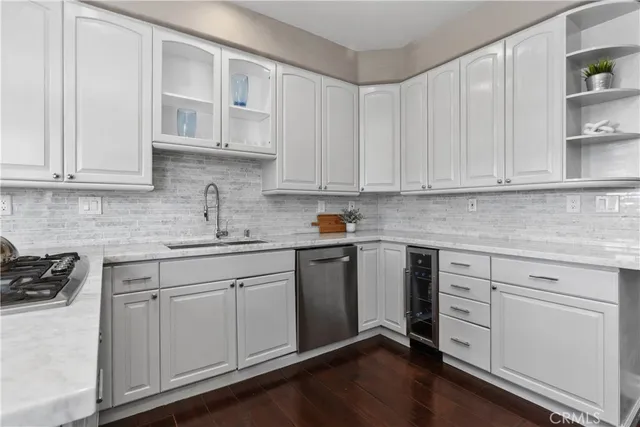 a kitchen with granite countertop white cabinets and white appliances