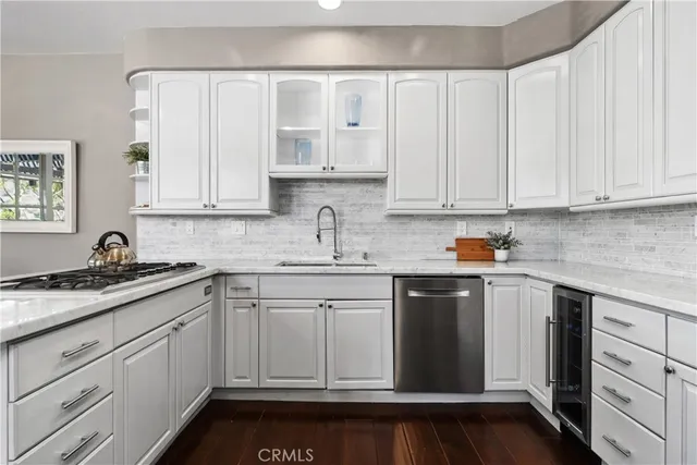 a kitchen with stainless steel appliances and refrigerator