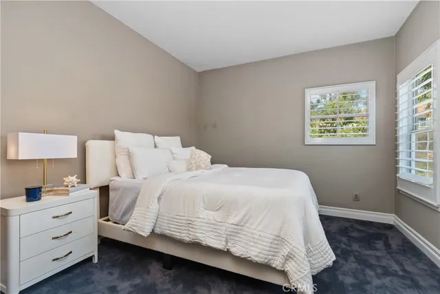 a bedroom with a bed and a night stand