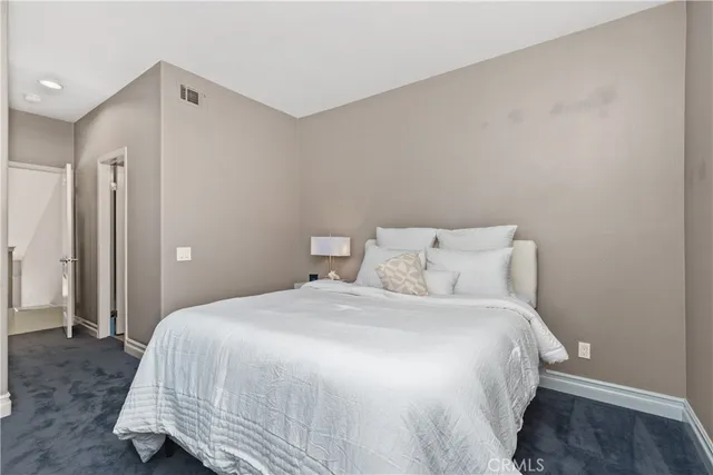 a bathroom with a granite countertop toilet sink and mirror