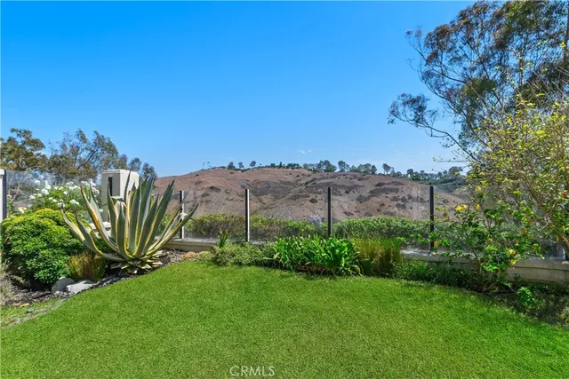 a view of a brick house with iron fence