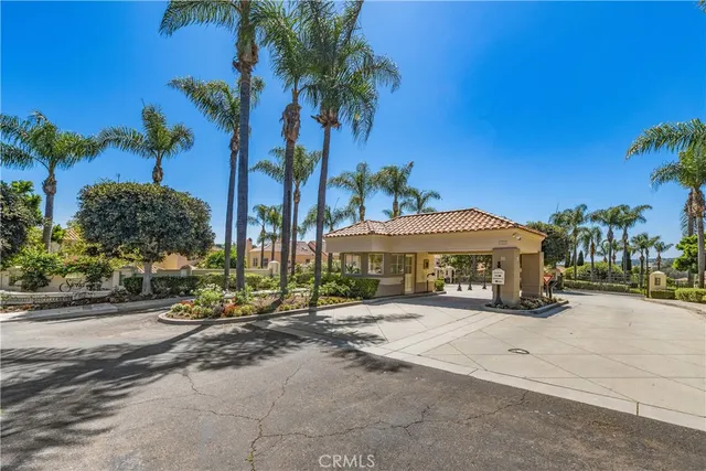 an aerial view of residential houses with outdoor space and parking