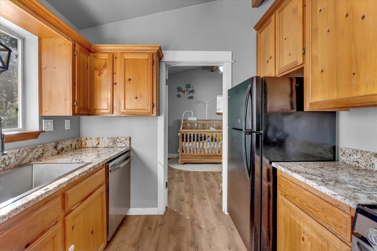 16150 Jellys Ferry Road Red Bluff, CA 96080 - Photo 7 of 37 a kitchen with a sink a refrigerator and cabinets