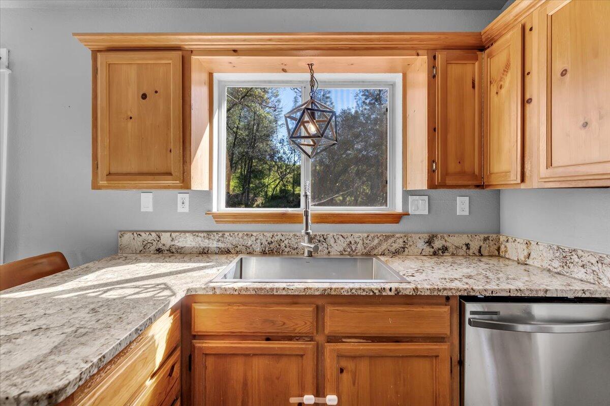 16150 Jellys Ferry Road Red Bluff, CA 96080 - Photo 8 of 37 a kitchen with granite countertop a sink and a window