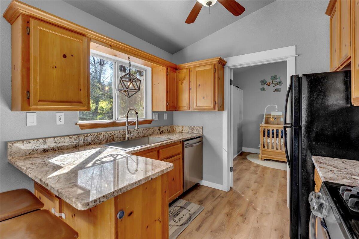 16150 Jellys Ferry Road Red Bluff, CA 96080 - Photo 9 of 37 a kitchen with stainless steel appliances granite countertop a sink stove and refrigerator
