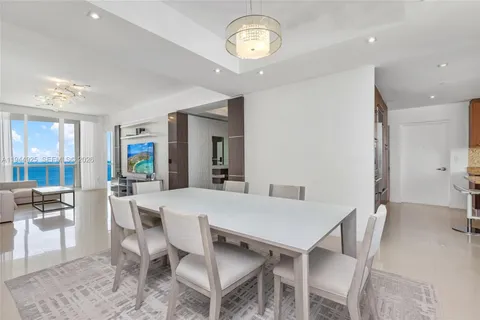 a view of a hallway with dining area