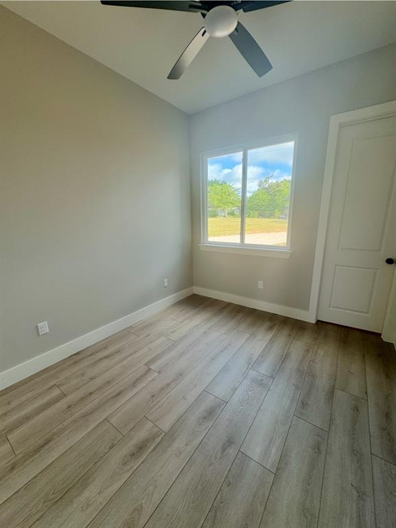 642 Fm 1995 Van, TX 75790 - Photo 19 of 28 an empty room with wooden floor and windows
