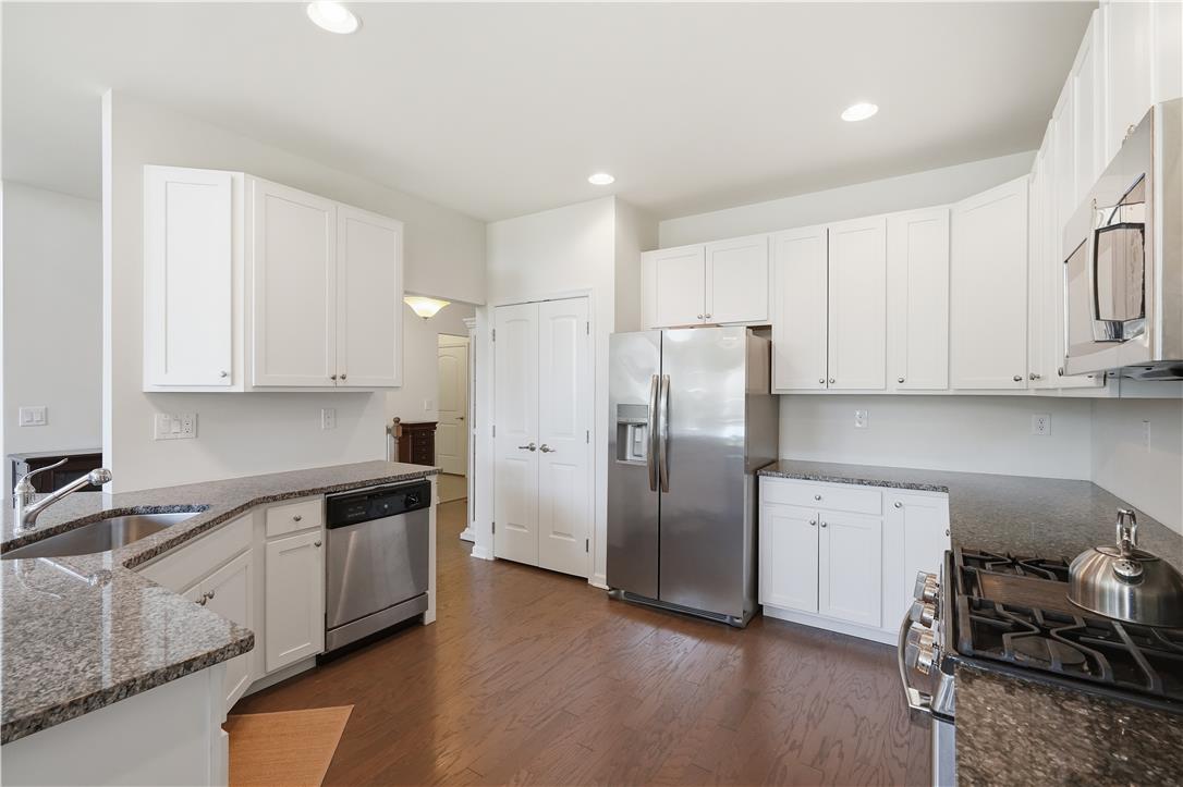 4120 Eveningstar Road Emmaus, PA 18049 - Photo 14 of 62 Prepare meals in a kitchen featuring granite counters, stainless steel appliances, and ample cabinetry.